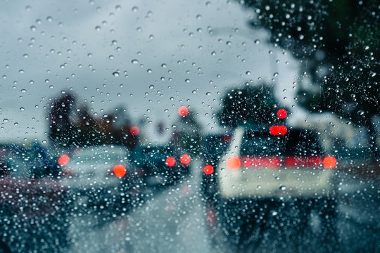 Heavy traffic during a rainy day; raindrops on the window