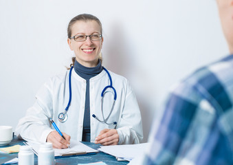 Woman doctor advises a sick patient in the office of the clinic.