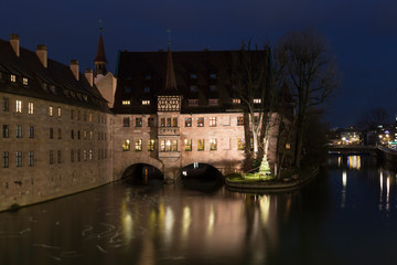 Heilig-Geist-Spital (Hospice of the Holy Spirit) in Old Town Nuremberg, Germany. View from the Museum Bridge on the River Pegnitz
