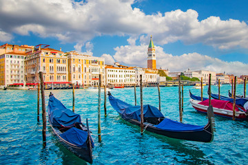 Fototapeta na wymiar Beautiful view of traditional Gondola on Canal Grande with St Mark's Campanile, San Marco, Venice, Italy.