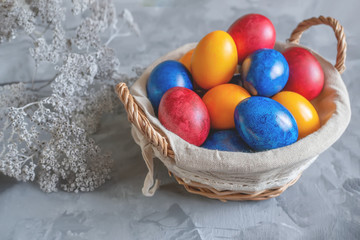 Colorful easter eggs lying in a basket on a beautiful vintage background. View from above. Easter Brunch