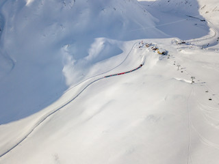 Aerial view of railroad through snow covered landscape in Switzerland