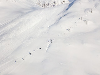 Fototapeta na wymiar Aerial view of ski chairlift on snow covered mountain in Switzerland