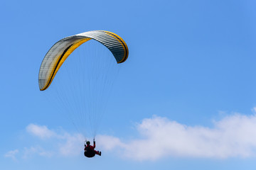 Flying on a parachute in the blue sky