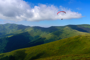Flying on a parachute in the blue sky