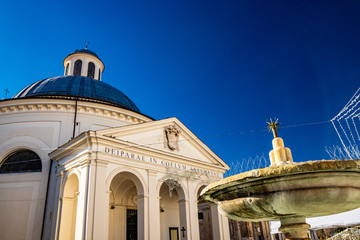 the church of Santa Maria Assunta, in the monumental Piazza di Corte, by Gian Lorenzo Bernini and the Chigi family. The dome, the bell tower and the fountain. Ariccia, Castelli Romani, Lazio, Italy.