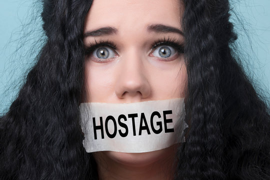 Portrait Of Young Woman With Mouth And Lips Sealed In Adhesive Tape Restrained And Abused Censored And Banned To Speak, Concept Of Hostage