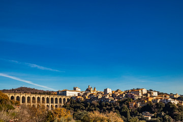 Fototapeta na wymiar View of Ariccia, with the monumental bridge, the baroque Chigi palace and the church of Santa Maria Assunta by Gian Lorenzo Bernini. Castelli Romani, Lazio, Italy.