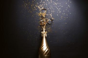 golden champagne on black background © Mykhailovskyi
