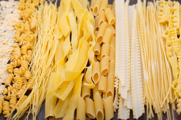 Different types of pasta, soup noodles and spaghetti. Food background.
