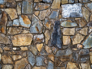 The texture of the wall paved with stone