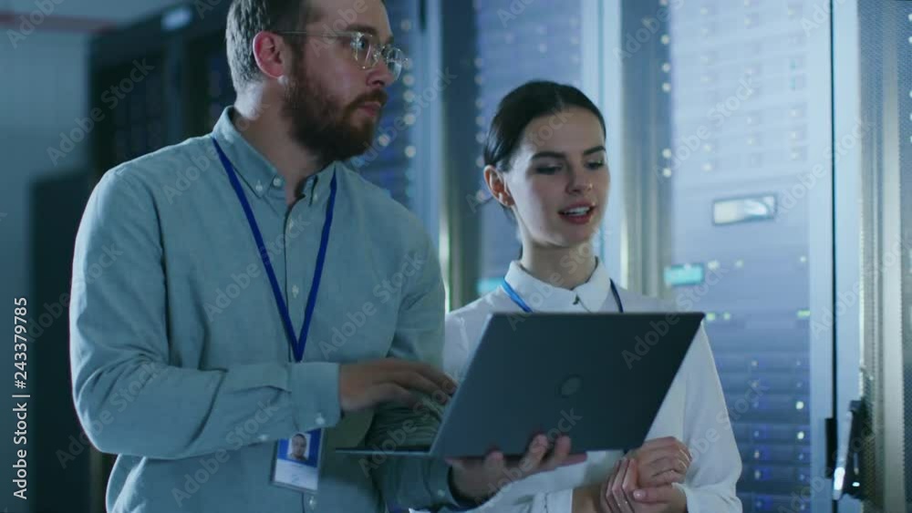 Aufkleber bearded it admin in glasses with a laptop computer and beautiful young technician colleague are talk