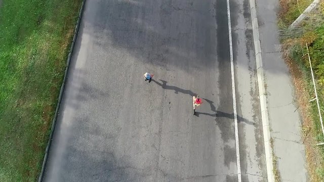 Zaporizhia  / Ukraine - 10.28.2018 Shooting athletes running under the quadcopter between the forest and the railway