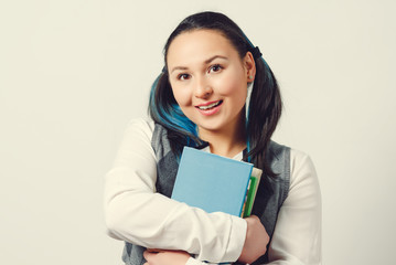 A young girl is a student of a high school student with a stack of textbooks in her hands. on white background