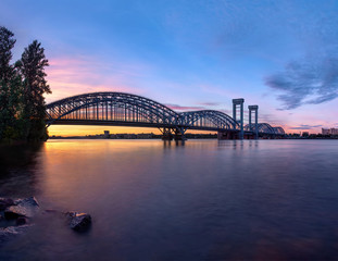 Fototapeta na wymiar railroad bridge at beauty sunset with flat water