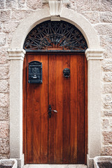 Ancient wooden door in old stone town with sandstone