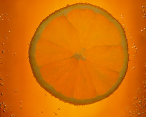orange slice with bubbles on orange background.