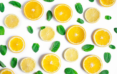 Orange and lemon slices with mint on a white background. Background for the design of banners,...