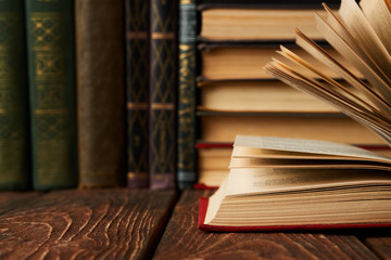 Stack of books on bookshelf, close-up. Education learning concep