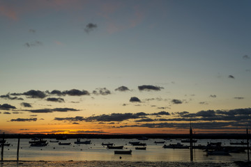 sunset at the sea and boats' silhouettes