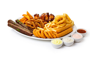 assorted appetizers of croutons, onion rings, French fries, cheese sticks,chicken wings, pork ears, squid in batter.