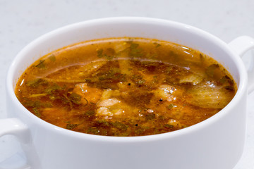 traditional soup kharcho in a ceramic Cup