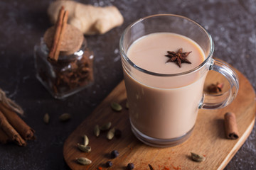 Masala chai tea on the dark background. Hot indian beverage with spices