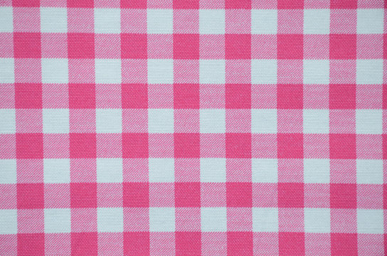 Pink plaid, checked texture, background. Pink and white checkered, vintage, old, retro abstract, textile. 