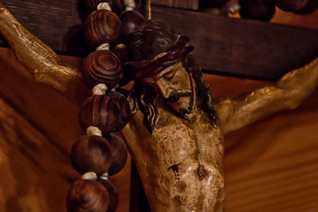 A detail of a small statue of the crucifixion of jesus christ.