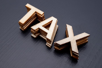 The inscription is arranged from letters cut out of wood on the table. The word – tax.