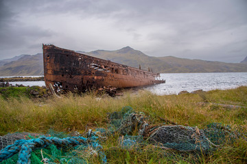 Rusty shipwreck on the coast at Djupavik, Iceland.