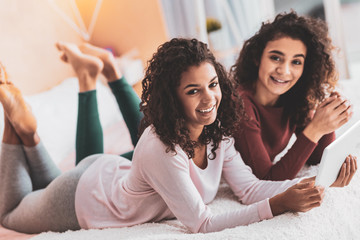 Siblings wearing leggings relaxing at home together