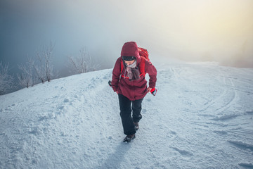 Fototapeta na wymiar Woman hike in winter snowy misty nature. Adventure in mountains