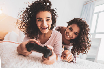 Friends laughing while spending free time with play station
