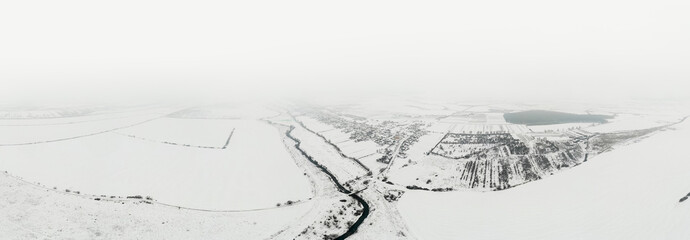 Winter panoramic landscape from above. Beautiful scenic 180 degree aerial panorama of the countryside