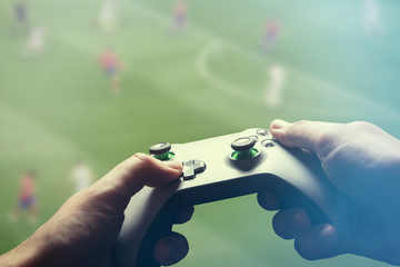 Video gaming console. Man playing soccer game