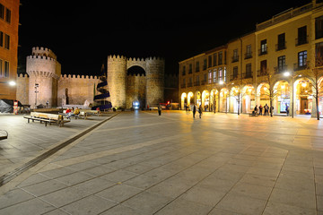 Avila, Spain - November 15, 2018: Square of Santa Teresa de Jesus and Puerta del Alcazar in the background.