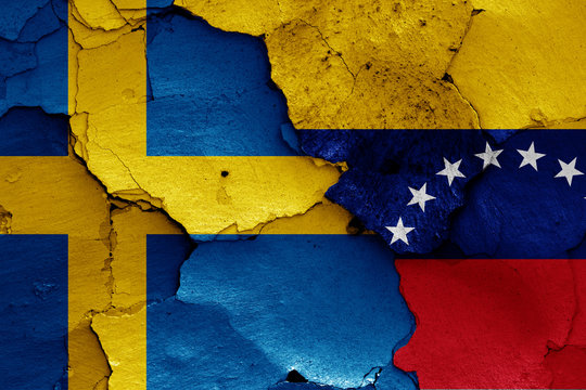 flags of Sweden and Venezuela painted on cracked wall