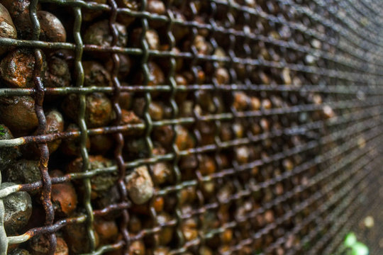 abstract metal with stone balls in background