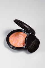 Pink and beige blusher or eyeshadow.