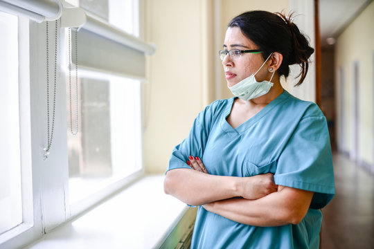 Female Nurse Staring Out The Window