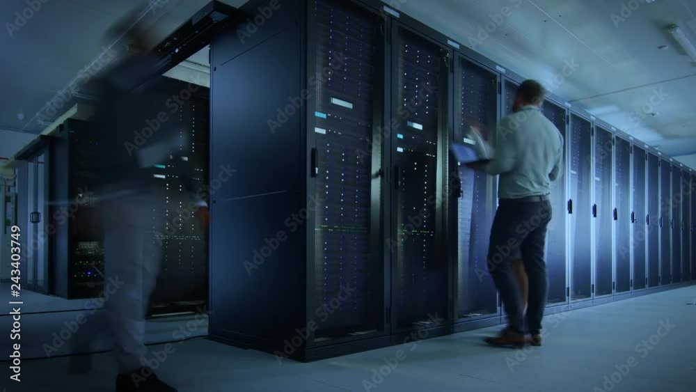 Poster Time Lapse Footage of IT Employees Working in a Data Center Server Room. Technicians and Engineers Running Diagnostics and Maintenance, Inspecting Server Racks.