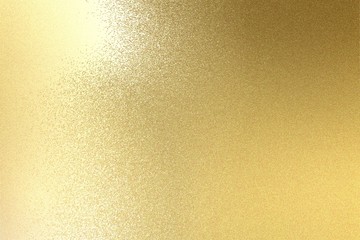 Light shining on brushed gold metal plate texture, abstract background