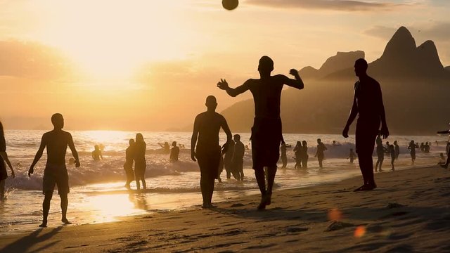 Joung man playing soccer, football on sand beach in Leblon, Copacabana, Rio de Janeiro, Brasil