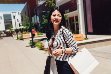 woman with shopping bags enjoying outdoor street