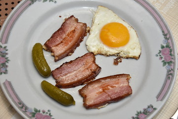 Morning food , Fried egg with bacon  and pickled cucumber