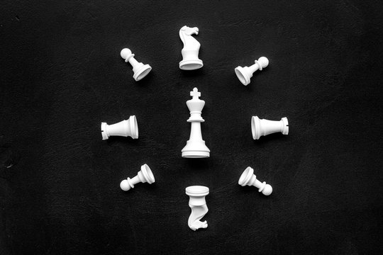 Competition or victory or strategy concept. Chess figures on black background top view pattern copy space