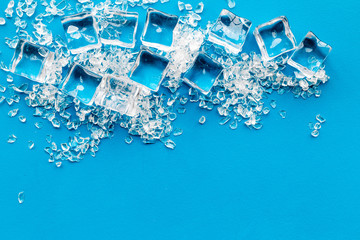 Frozen water in ice cubes on blue bar table top view mockup