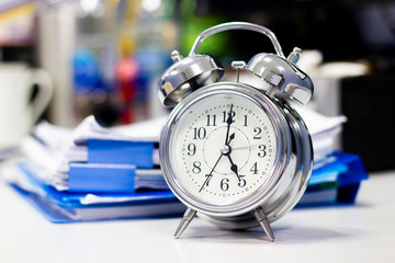 clock on work desk in the office Time of businessman working concepts 