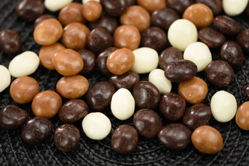 Dark ,white,brown dragee in chocolate 